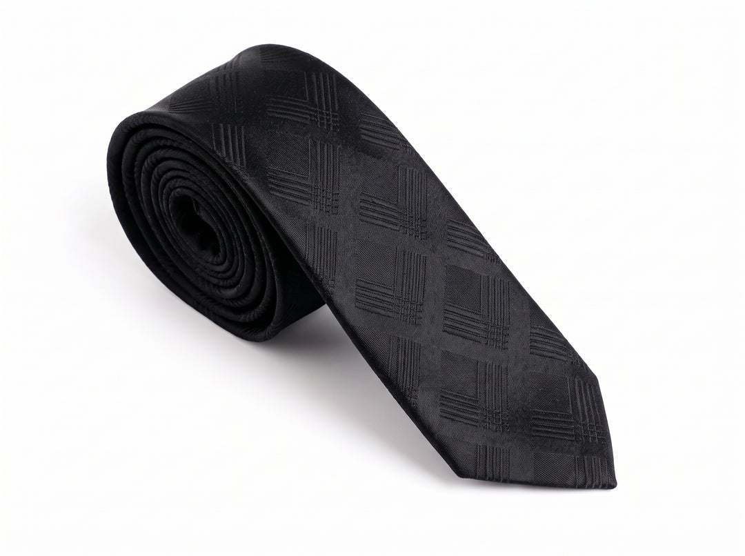 A black textured necktie with a subtle diagonal grid pattern, rolled on the left and laid out diagonally on a white background.