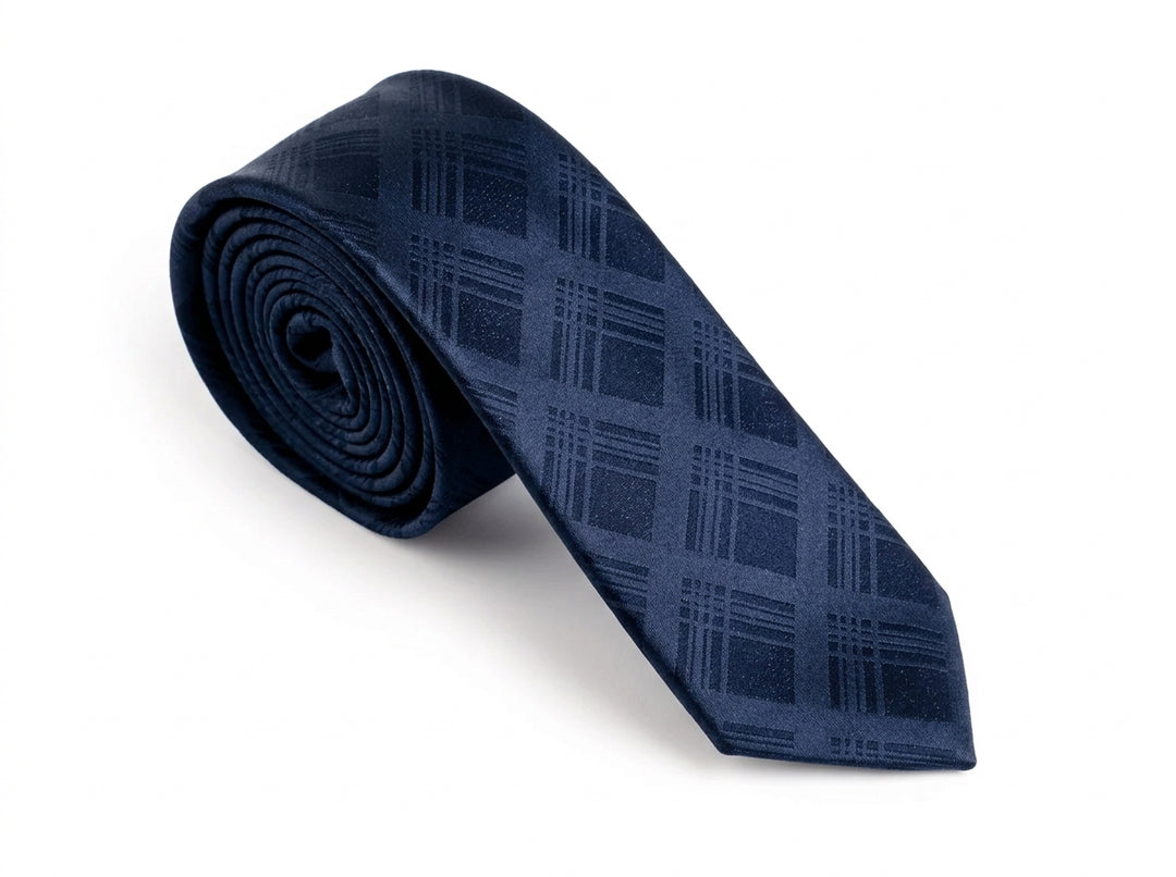 A navy blue necktie with a subtle plaid pattern, rolled on the left and laid out diagonally on a clean white background.