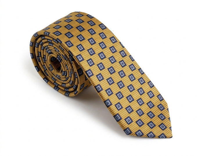 A rolled-up necktie featuring a textured mustard yellow base with a repeating pattern of small blue and white diamond motifs, set against a plain white background.