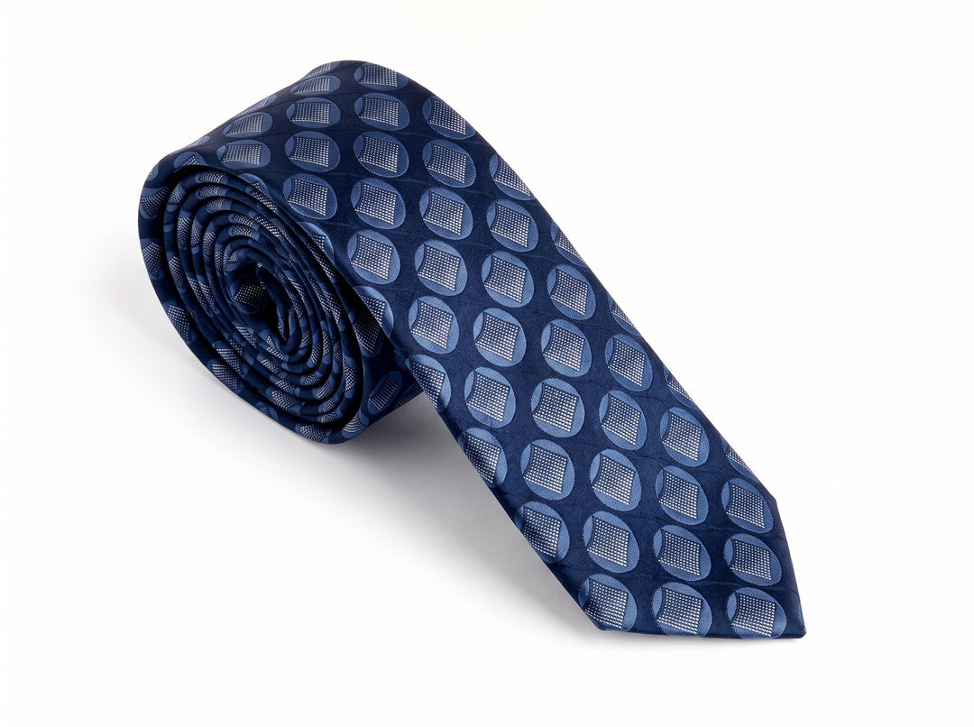 A rolled-up navy blue silk necktie featuring a repeating geometric pattern of light blue and gray oval motifs, displayed on a clean white background.