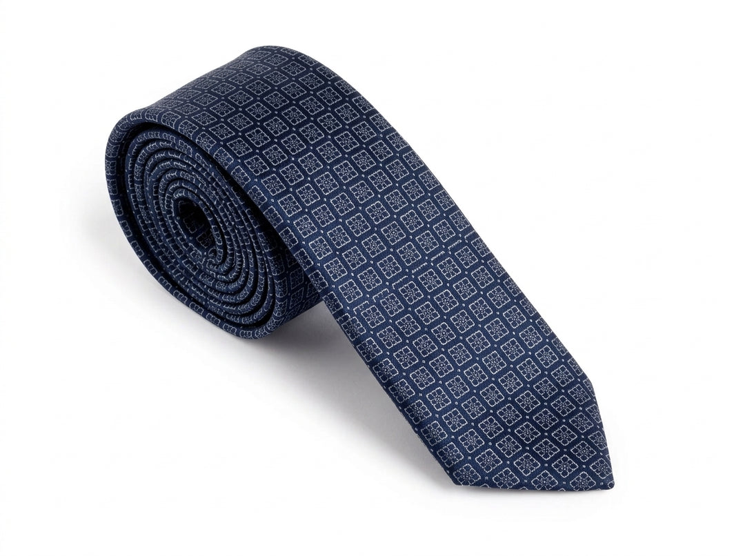A rolled navy blue silk necktie with a repeating small geometric diamond pattern, displayed on a clean white background.