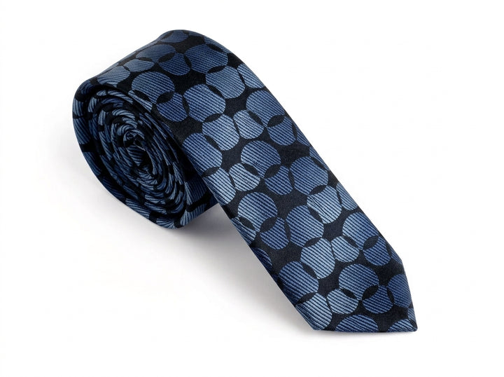 A rolled necktie featuring a geometric pattern of interlocking blue and black circles, displayed on a clean white background.