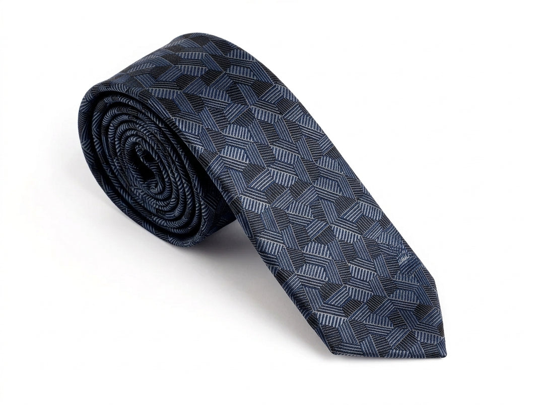 A rolled-up necktie featuring a dark navy blue and gray geometric pattern, displayed on a clean white background.