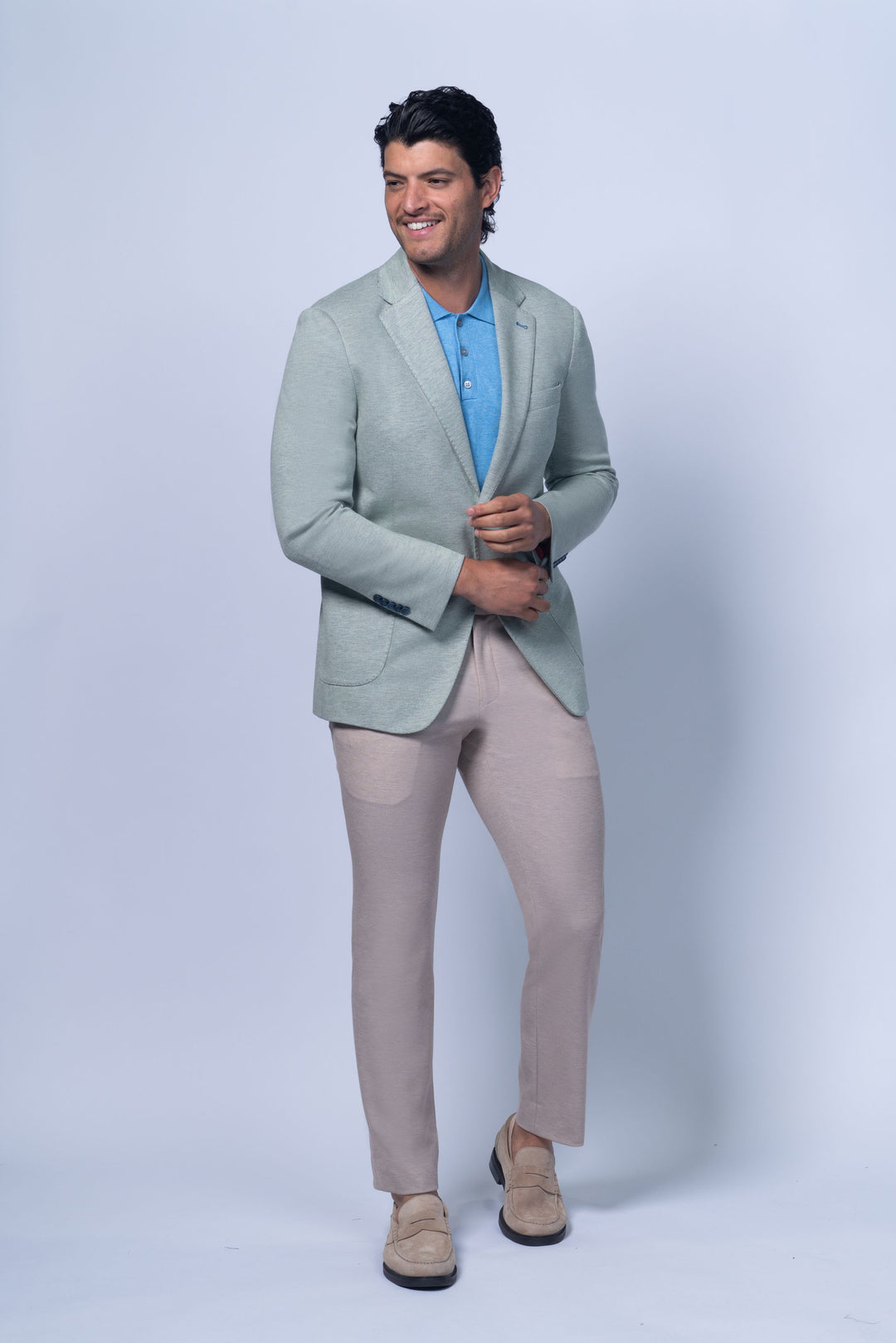 Light green Brighton Green Jersey Stretch Knit jacket worn over a blue polo shirt, styled with beige pants.