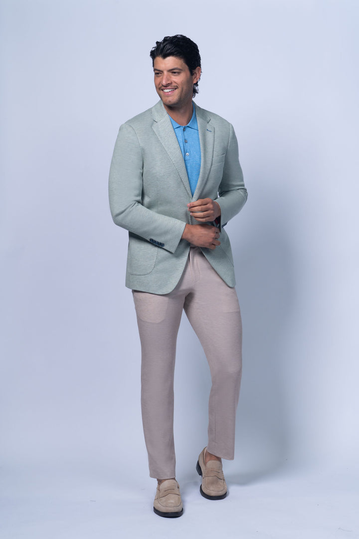 Light green Brighton Green Jersey Stretch Knit jacket worn over a blue polo shirt, styled with beige pants.
