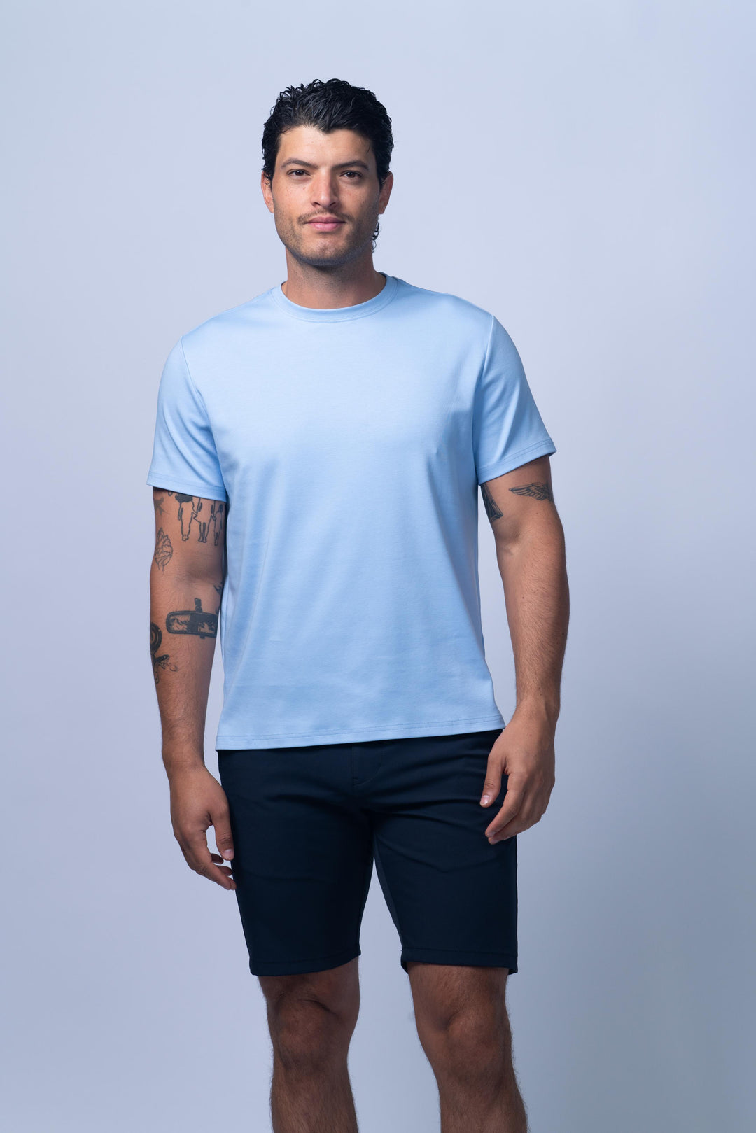 Man wearing a light blue t-shirt and dark shorts