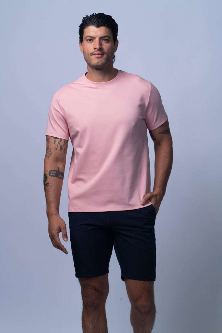 Man wearing a pink t-shirt and black shorts