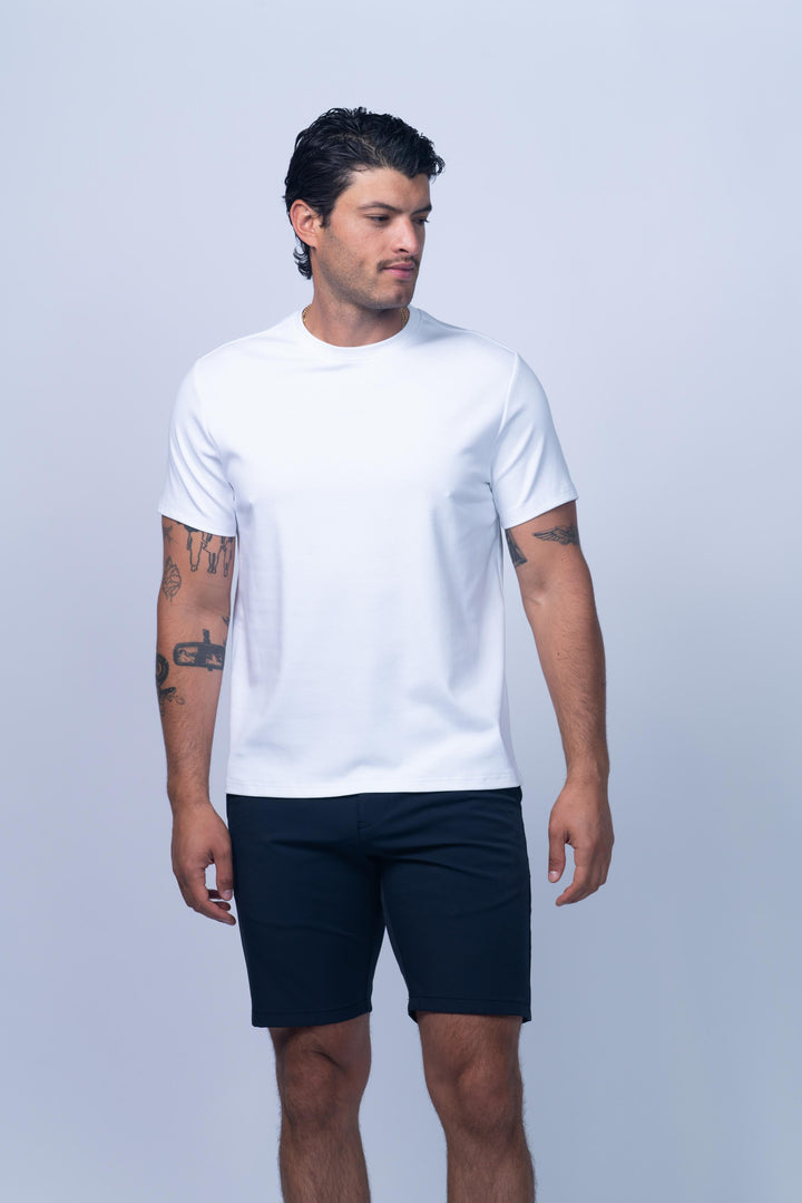 Man wearing a white t-shirt and navy shorts 