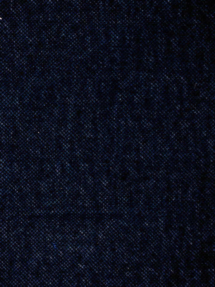 A close-up of dark navy blue textured fabric with a fine woven pattern.