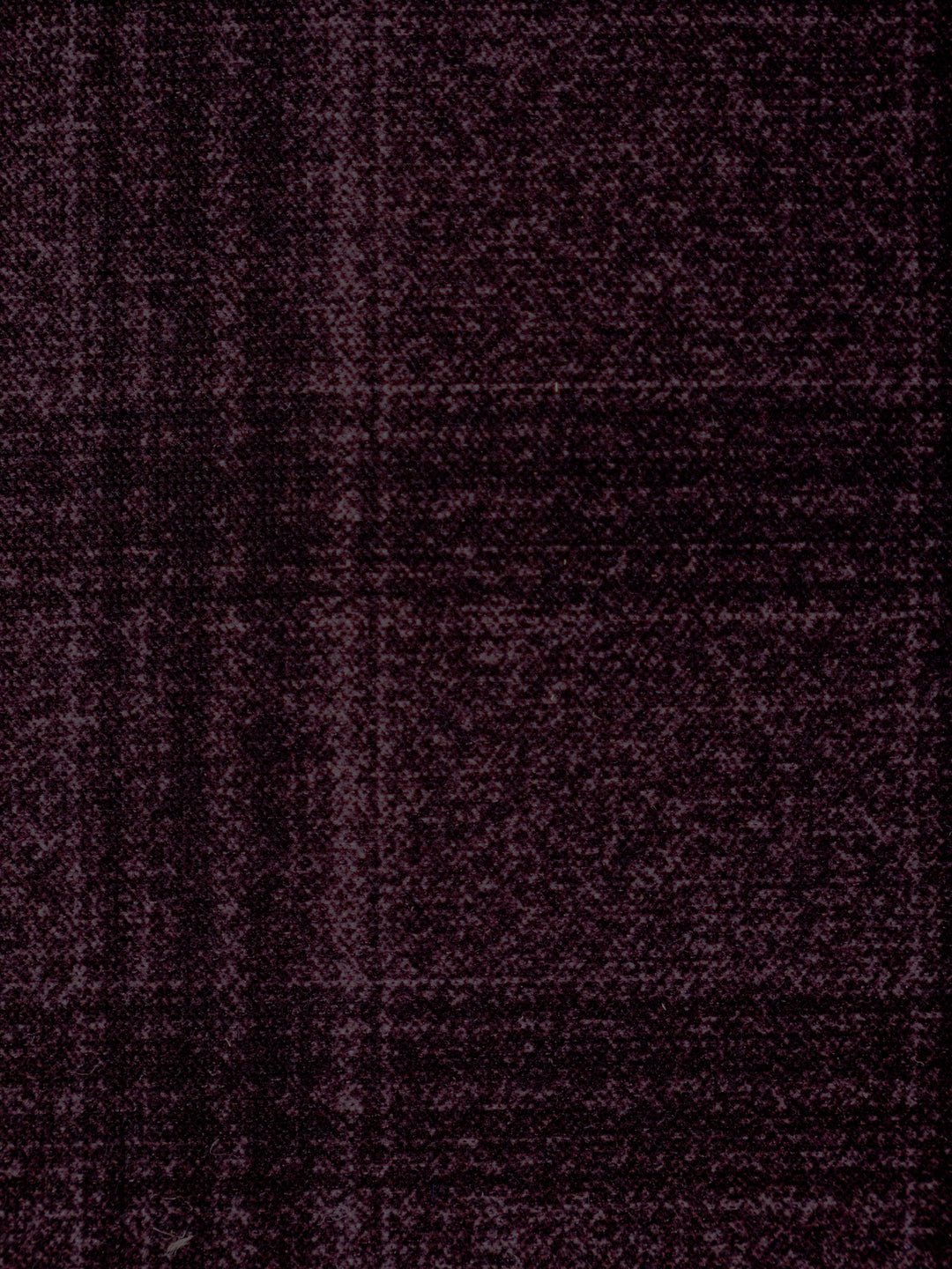 A close-up of a dark plum purple textured fabric with a subtle woven plaid pattern.