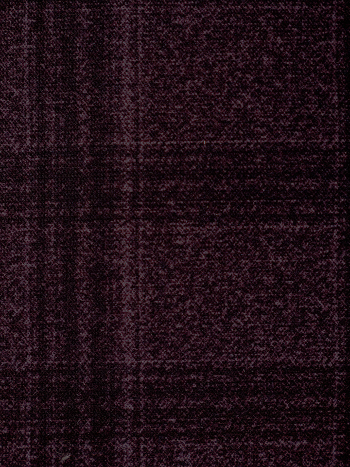 A close-up of a dark plum purple textured fabric with a subtle woven plaid pattern.
