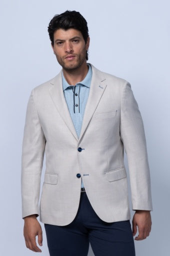 Tan twill stretch blazer with notched lapels, two-button closure, and front pockets, styled over a light blue polo shirt.
