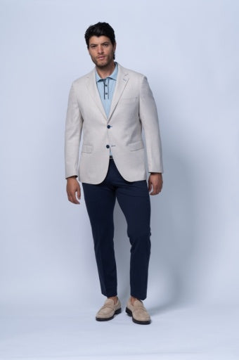 Tan twill stretch blazer worn over a light blue shirt, showcasing tailored fit and structure with dark trousers.
