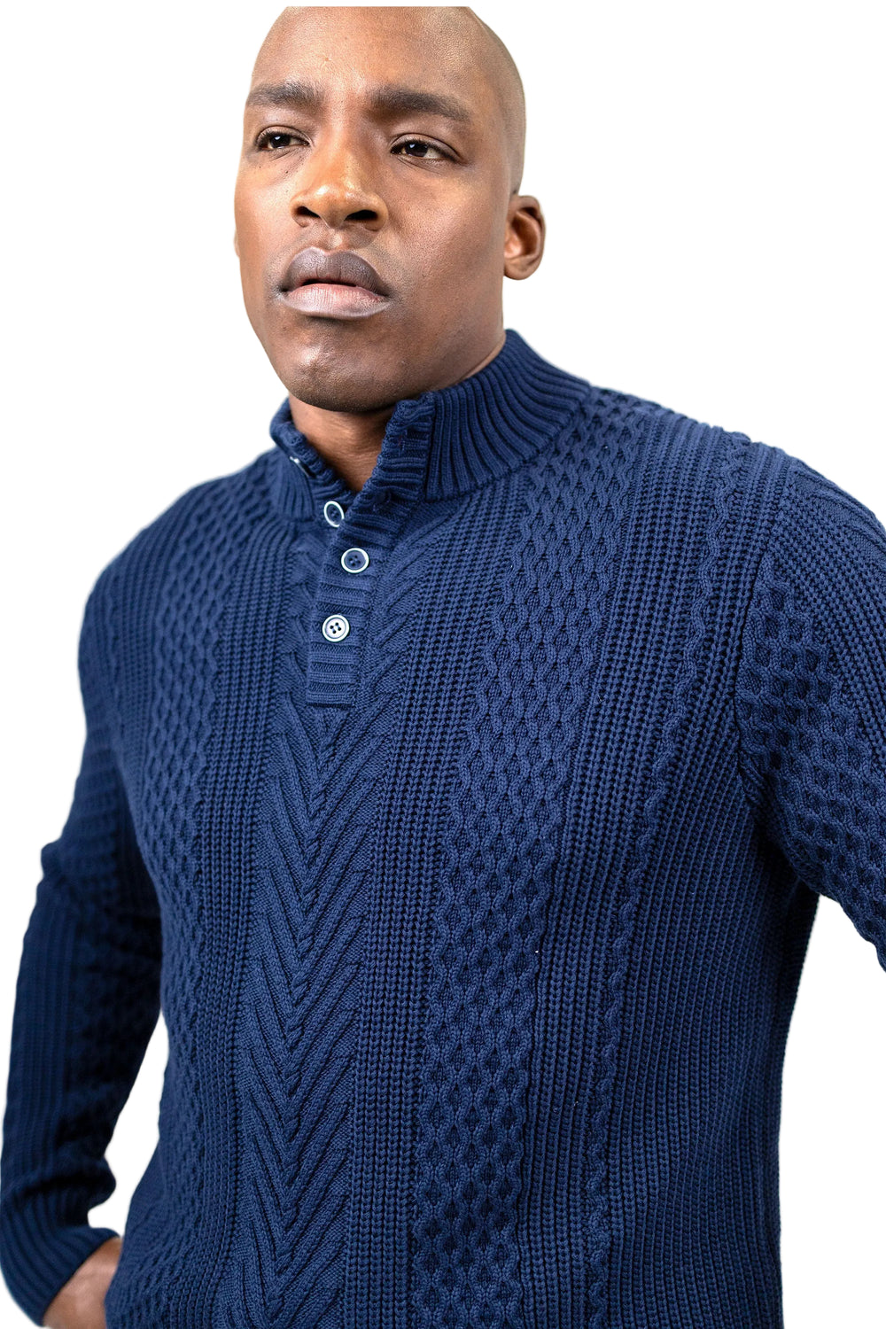 A man wearing a navy blue cable-knit mock-neck sweater with a three-button placket, photographed against a plain white background.